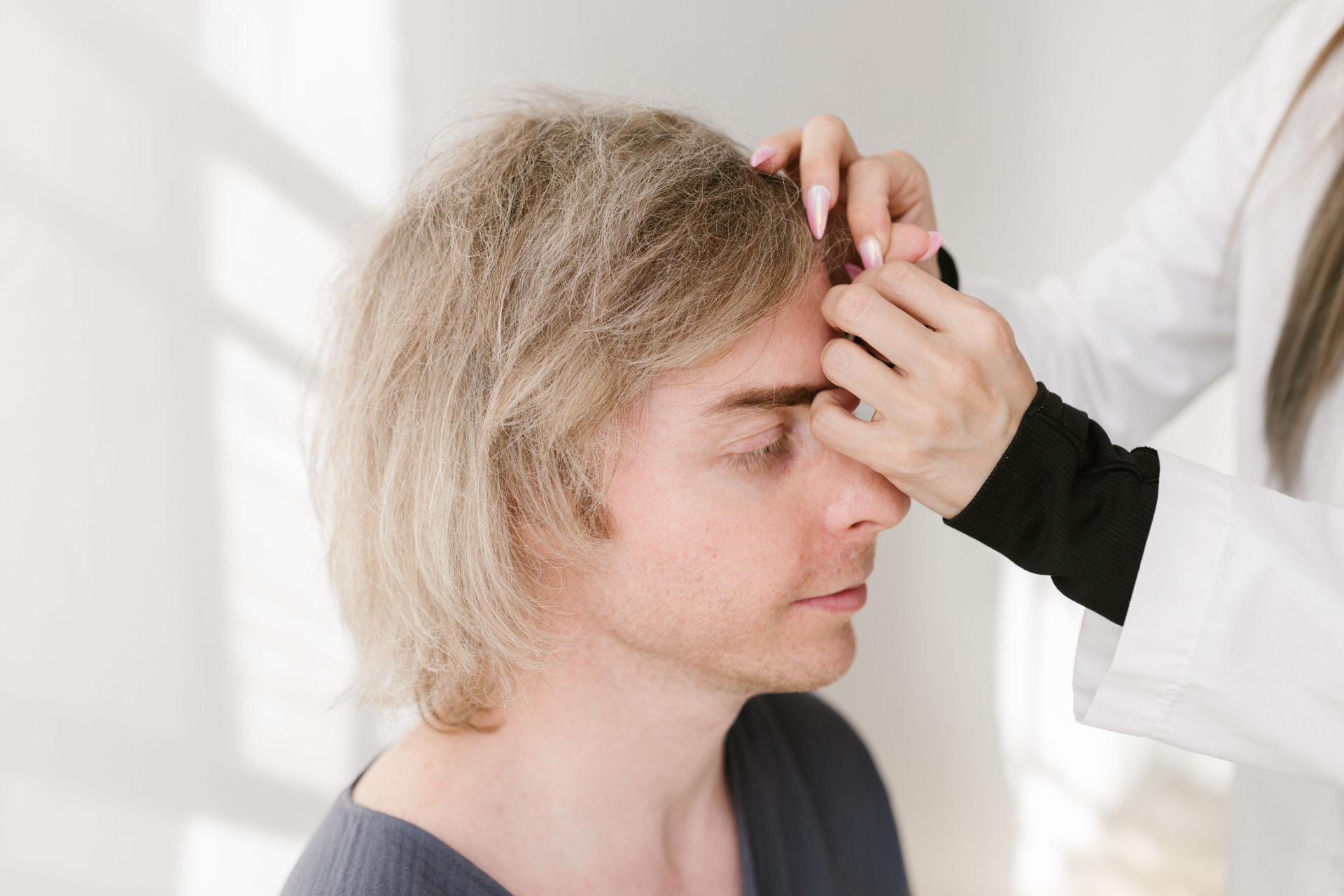 Clinician reviewing scalp analysis images with a client during consultation